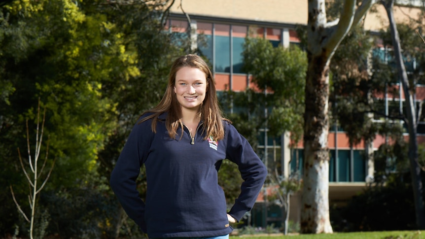 Melbourne University agriculture student Charlotte Morrison standing on grass at the university