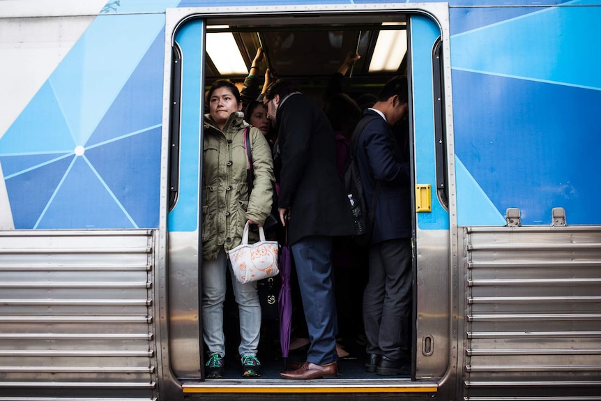 Commuters tightly packed onto a train at Caulfield.