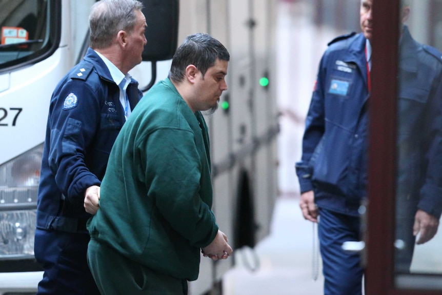 Mohamed Naddaf is seen leaving a prison van as he enters the Supreme court in Melbourne.