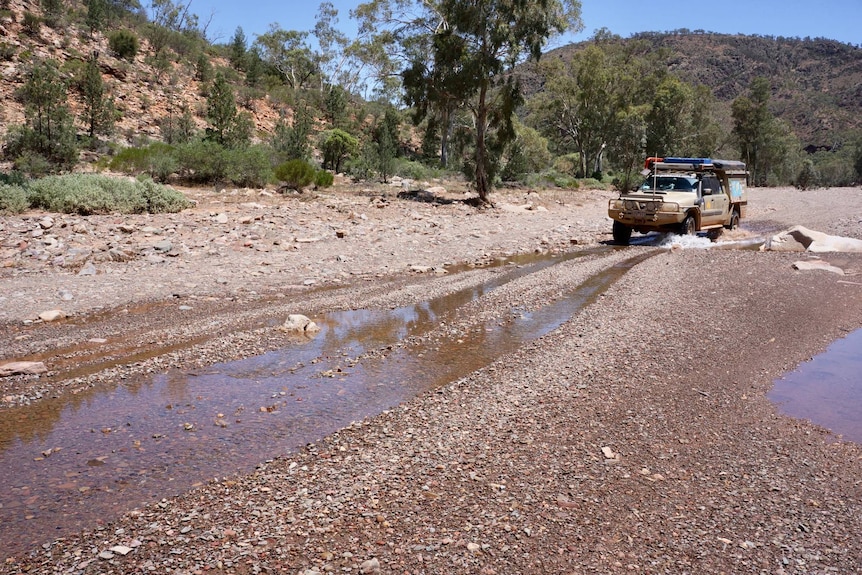 A four-wheel drive goes through water in the Flinders Ranges in South Australia.