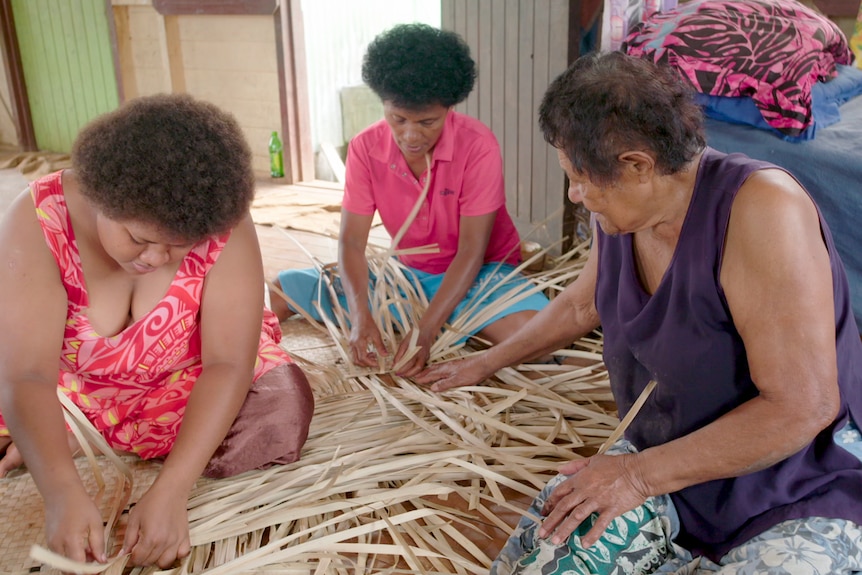 Women weave mats.