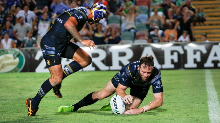 The Cowboys' Gavin Cooper (R) scores the winning try in golden point against Canberra in Townsville.
