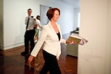 Julia Gillard leaves a Caucus meeting in Canberra