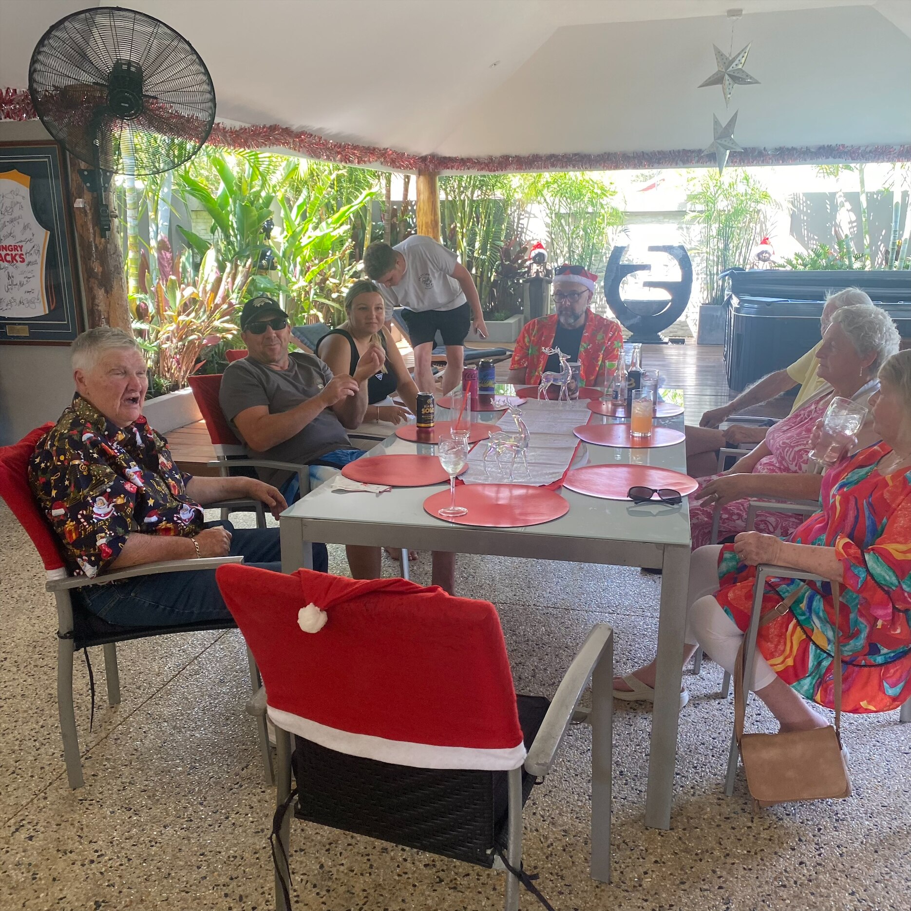 A group of people sitting outdoors with Christmas decor