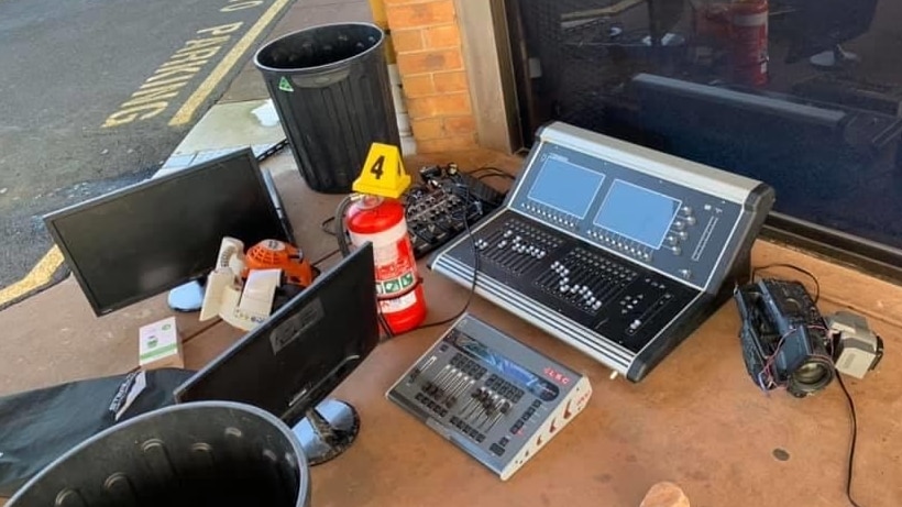 A sound mixer, monitors, a fire extinguisher and a police evidence sign on the ground