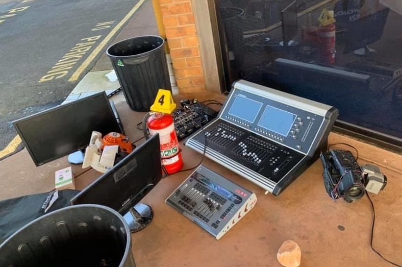 A sound mixer, monitors, a fire extinguisher and a police evidence sign on the ground