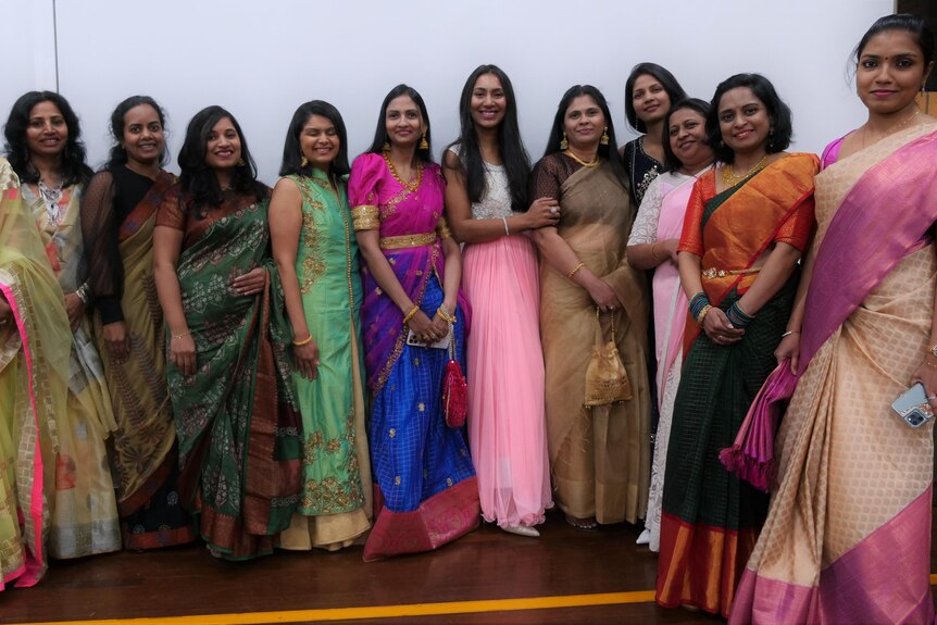 Indian women wearing traditional saris of many different colours and styles