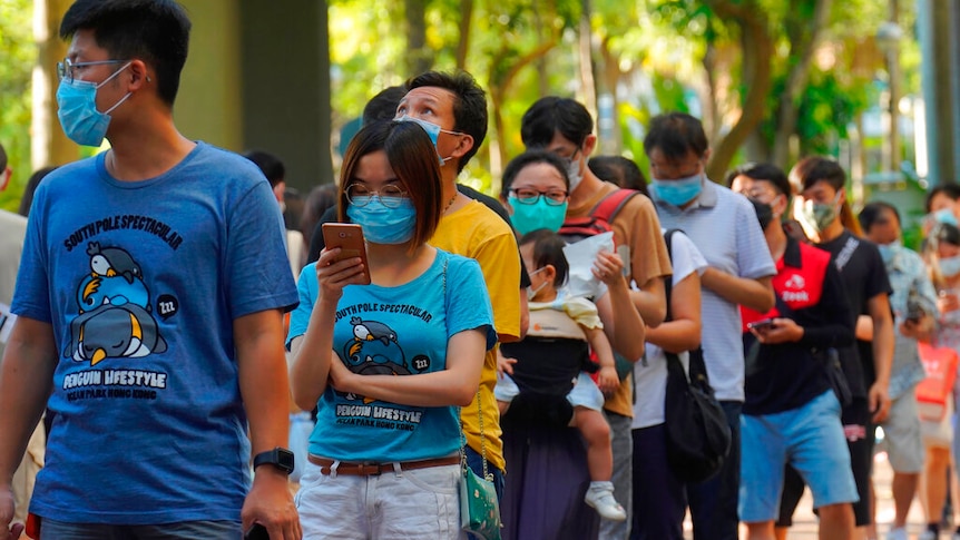 People queue up to vote in Hong Kong Sunday, July 12, 2020, in an unofficial primary for pro-democracy candidates.