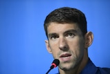 Michael Phelps speaks to the media
