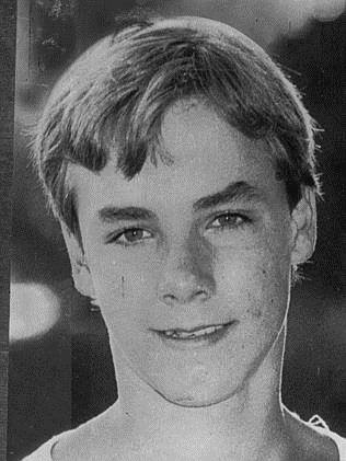 A black and white photo of a teenager from the 1980s