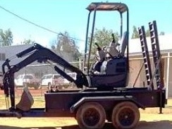 A small black excavator on a trailer