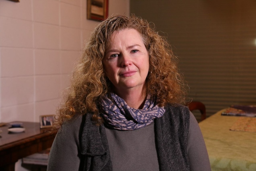 A woman with long wavy brown hair.