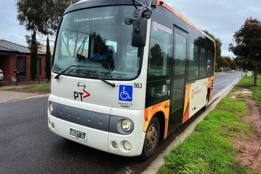 A bus parked on a suburban street.