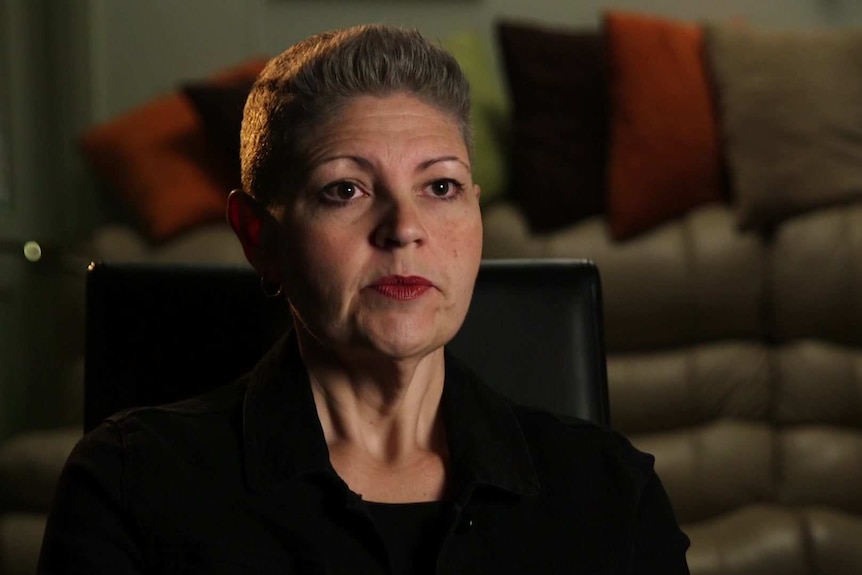 Head shot of juror Kerri Bellew with a blurred background of orange, green and brown cushions