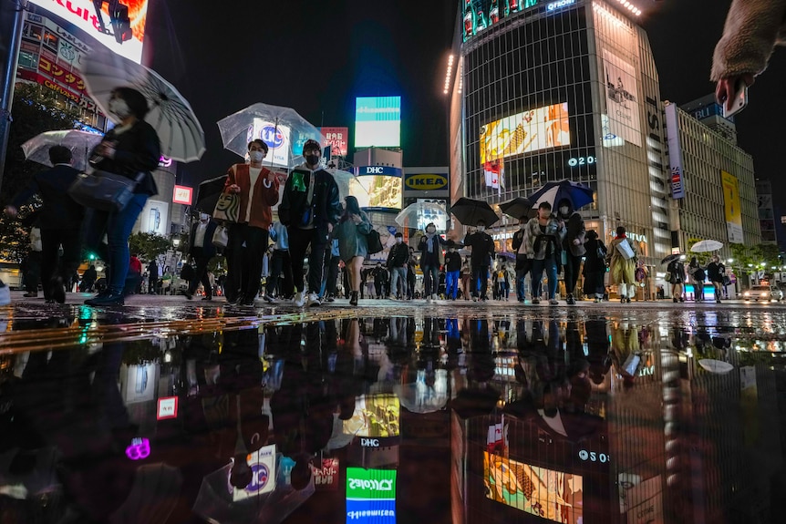 People wearing face masks on the Shibuya scramble crossing in Tokyo