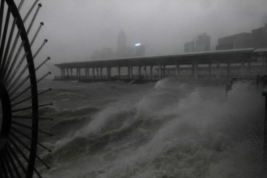 Strong wind caused by Typhoon Mangkhut in Hong Kong pushes waves up onto the waterfront at Victoria Harbour.