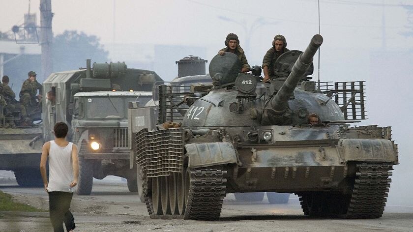 A Russian military column drives through the township of Alagir