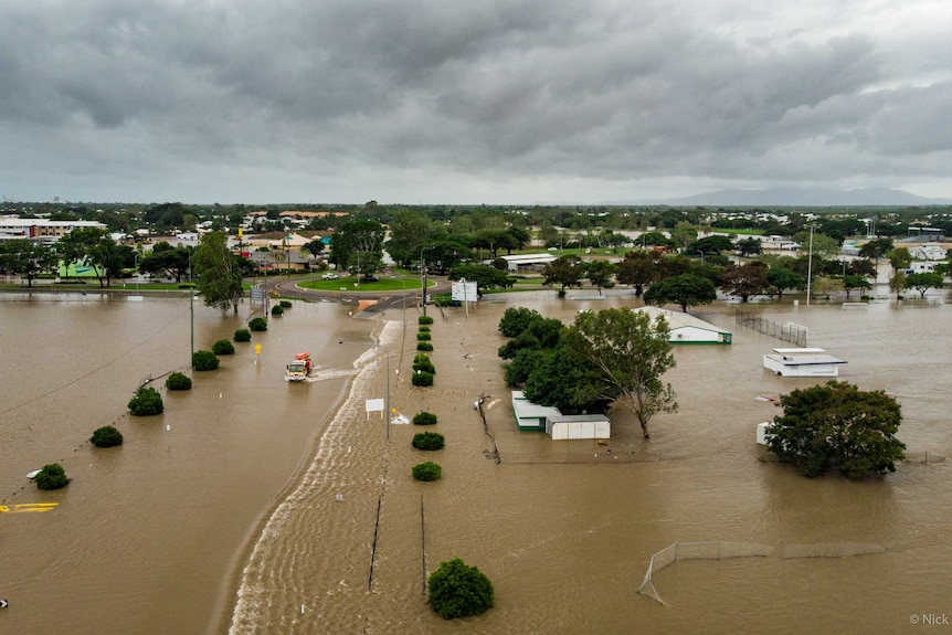 A truck driving through on a flooded road in an aerial photo of flooded Townsville.
