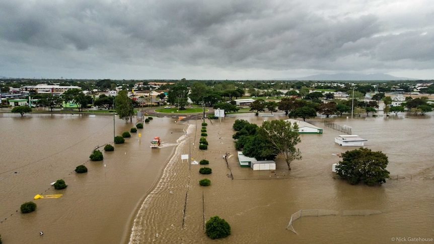 A truck driving through on a flooded road in an aerial photo of flooded Townsville.