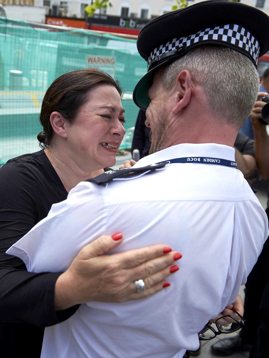 Survivor embraces police rescuer