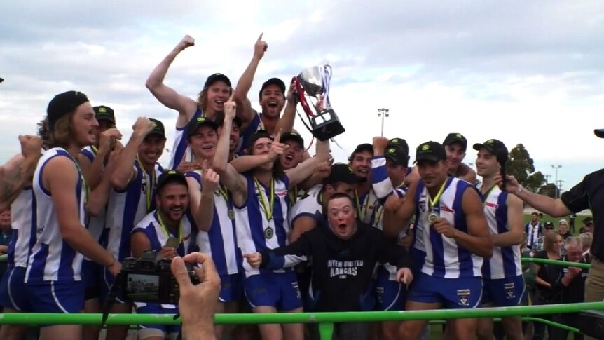 Kangas football team celebrate win with trophy