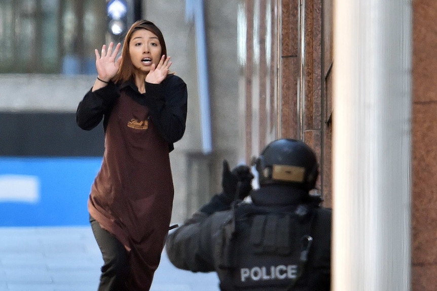 Woman runs out of building during siege in Martin Place