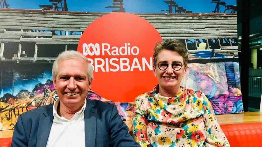 Graham Young and Rachel Nolan sitting on a lounge with an ABC sign behind them