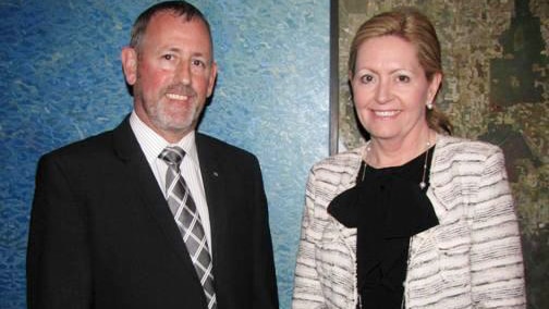Gary Stevenson stands wearing a suit and tie alongside City of Perth Mayor Lisa Scaffidi.