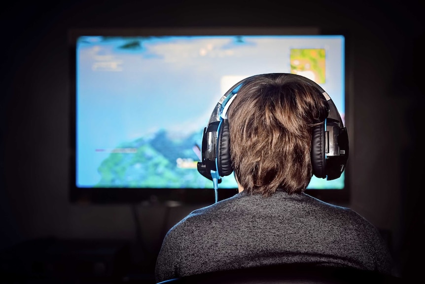 Man playing video games with headphones
