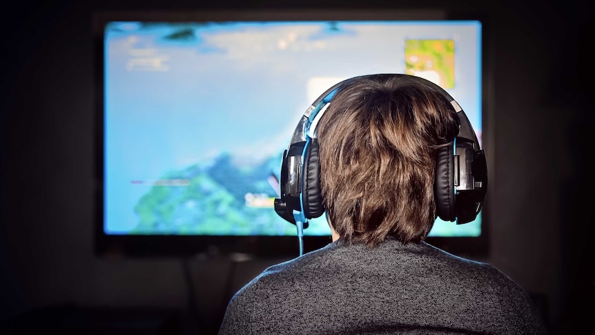 Man playing video games with headphones