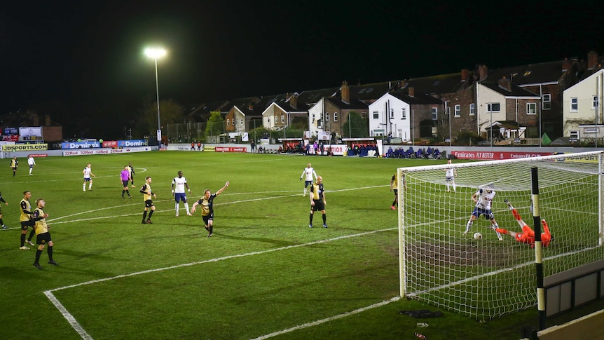 A general view of a football pitch with houses backing onto the field.