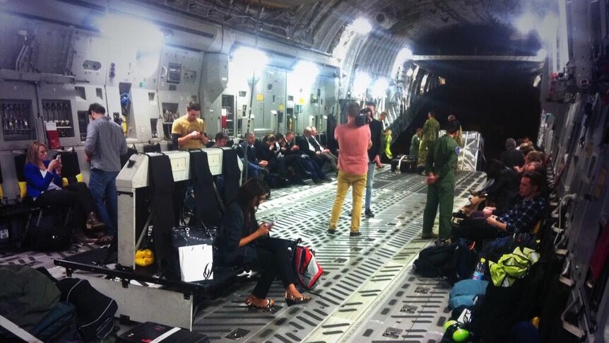Journalists sit in a C-17 Globemaster provided for the media on the federal election campaign trail.