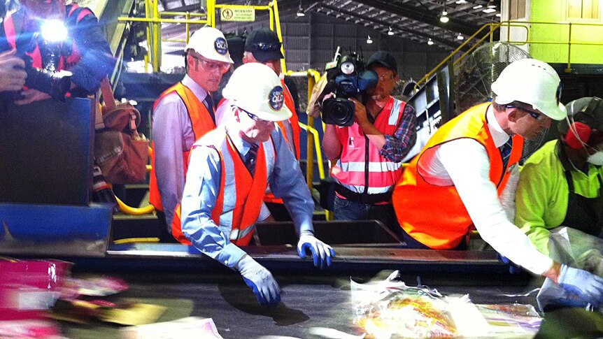 Campbell Newman and Tony Abbott get their hands dirty at the VISY recycling plant at Gibson Island.