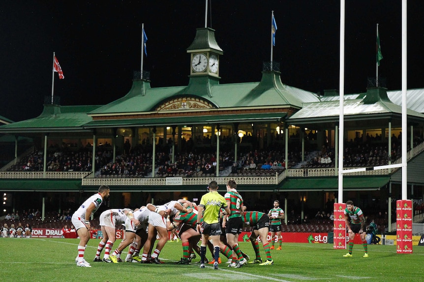 Two rugby league team engage in a scrum during a game