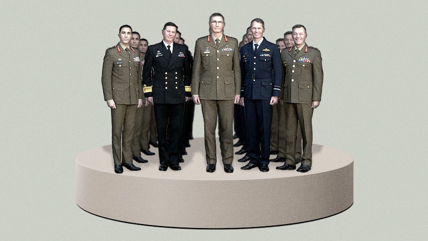 Five men in defense uniforms stand on a platform. 