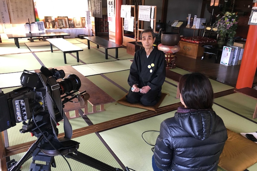 Japanese Buddhist monk sits in the temple near Fukushima