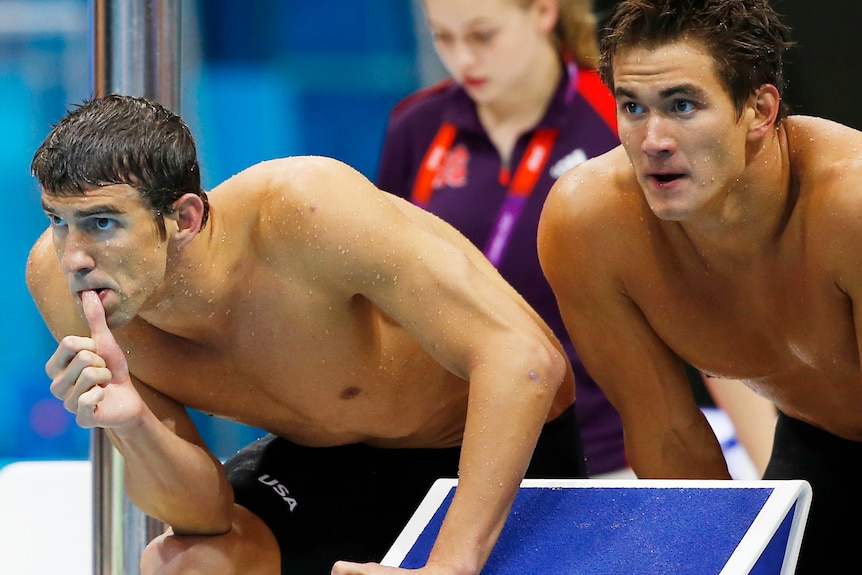 Michael Phelps and Nathan Adrian (R) of the US look on during the 4x100m freestyle relay final.