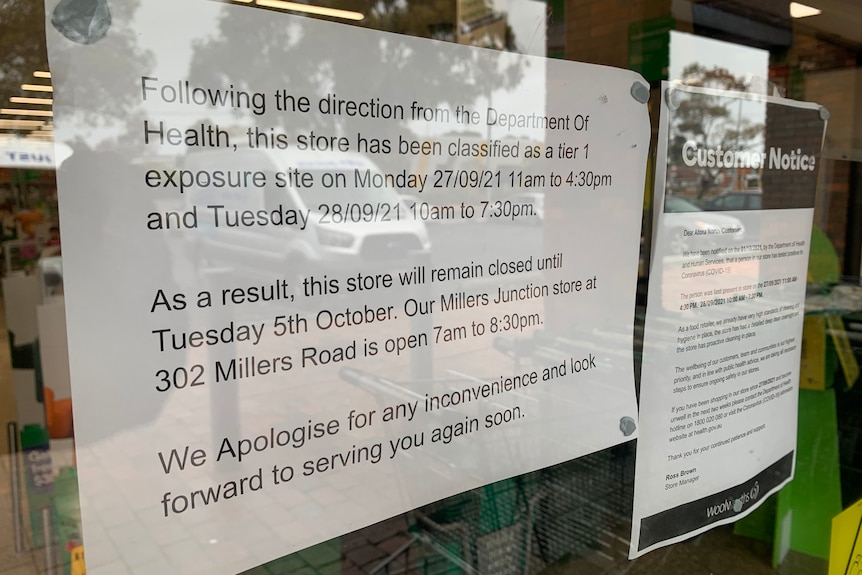 A sign in a shop window advising of closure due to COVID