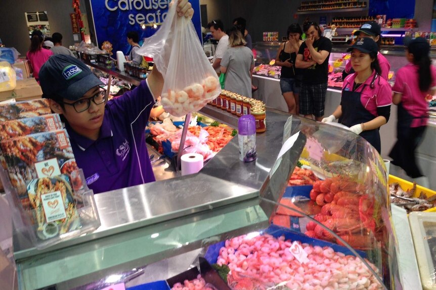 A busy seafood shop selling prawns in Perth.