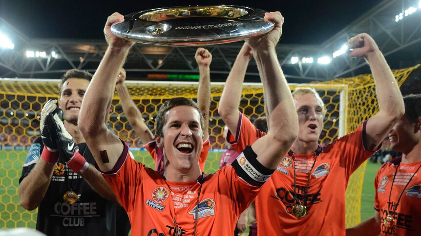 Matt McKay lifts the A-League championship trophy