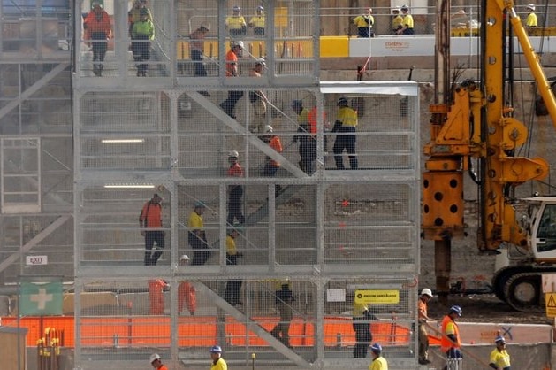 Construction workers descend using temporary stairs on a major construction site in central Sydney