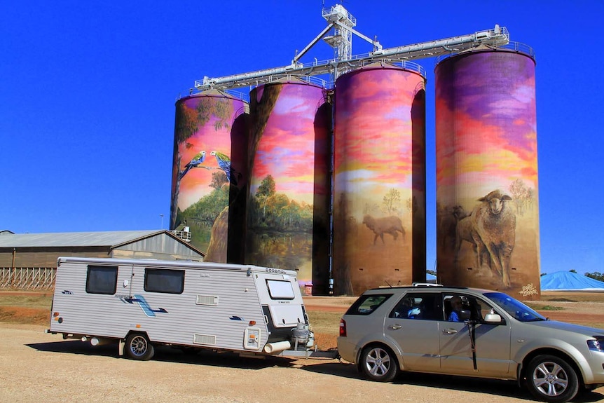 Tourists visit Thallon in south-west Queensland in July 2017, where four silos have been painted with landscape artwork.