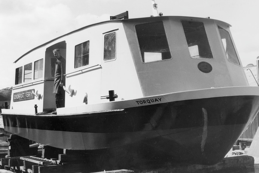 a black white photo of a ferry boat 
