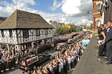 Mourners watch procession of hearses of British soldiers