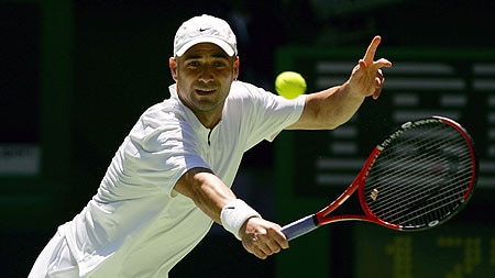 Andre Agassi plays a backhand against Joachim Johansson