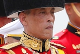 Thailand's King Maha Vajiralongkorn walks in a funeral procession of his father wearing military garb