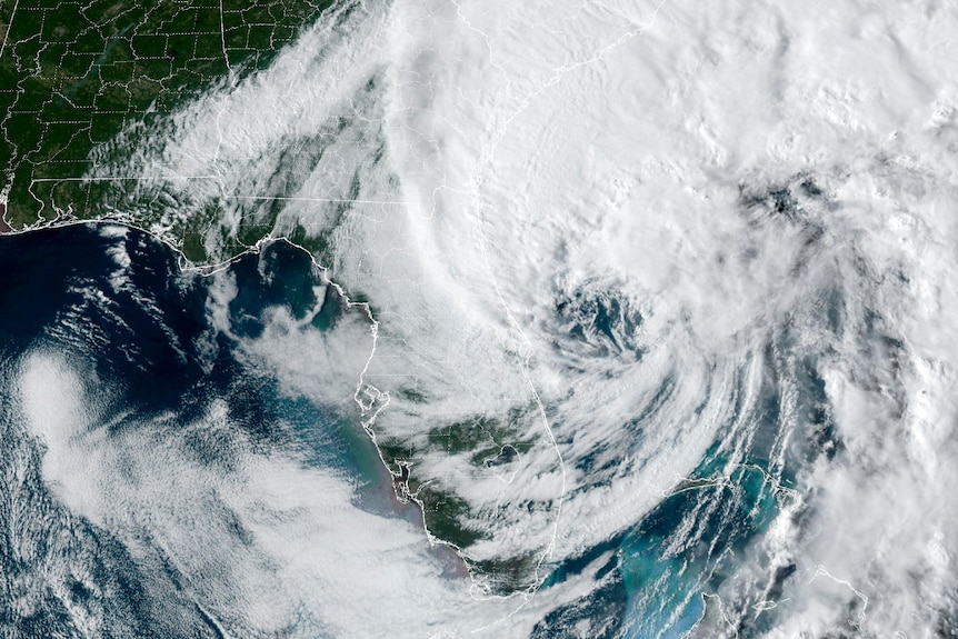 A satellite picture with some coastlines and US counties highlighted shows a large hurricane off the east coast of Florida.