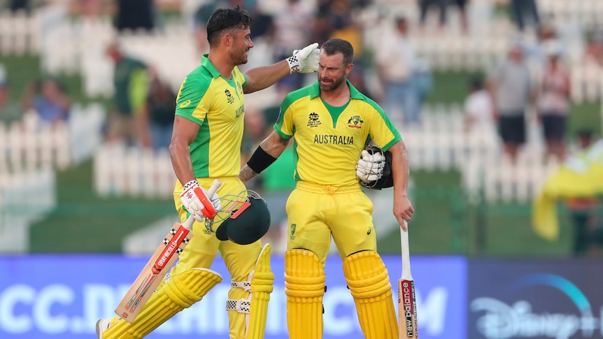 Two Australian male batters congratulate each other after hitting the winning runs against South Africa.