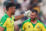 Two Australian male batters congratulate each other after hitting the winning runs against South Africa.