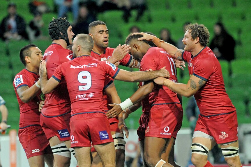 The Reds celebrate an Eto Nabuli try against the Rebels in Melbourne.